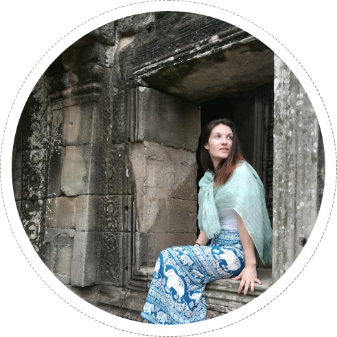 cecile (author of this blog) seet on ruins of a temple in indonesia
